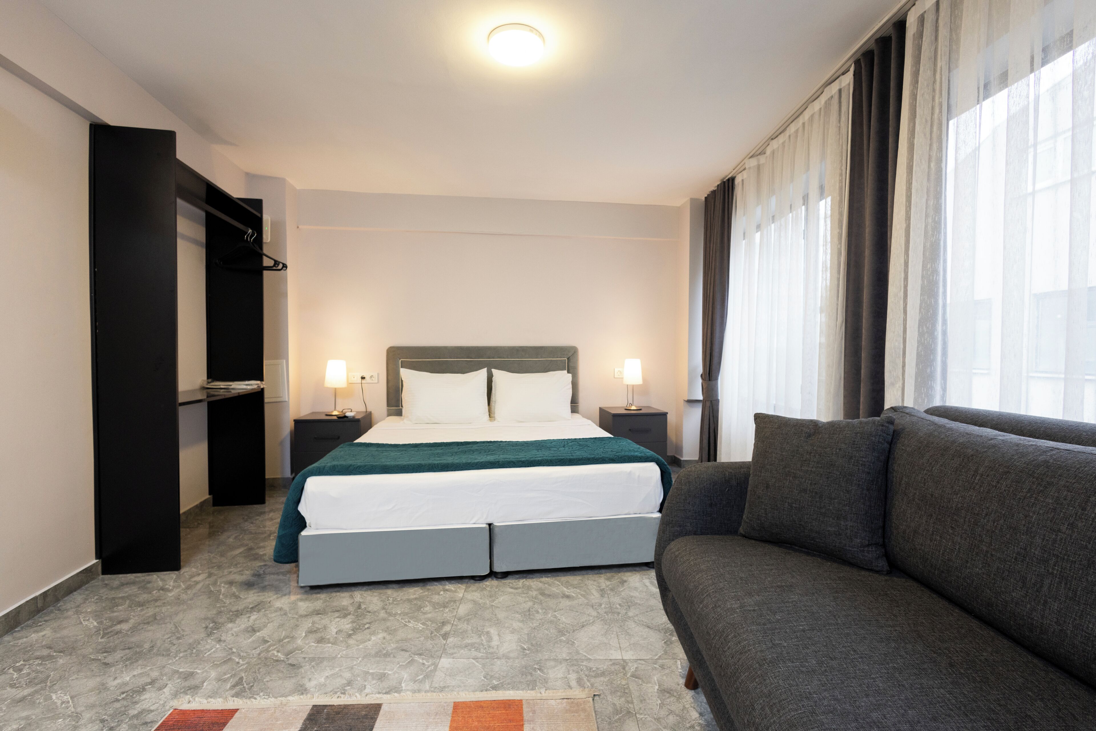 Standard Studio | Desk, laptop workspace, blackout curtains, iron/ironing board