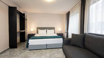 Standard Studio | Desk, laptop workspace, blackout curtains, iron/ironing board