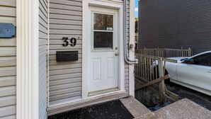 A residential house with a white door, a mailbox, and the number 39 on the door.