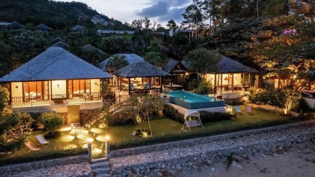 A resort with multiple overwater bungalows, a swimming pool, and lush landscaping. - Luxury Beachfront Pool Villa - Finu@Samui (Koh Samui)