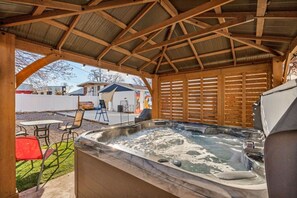 A hot tub under a wooden pergola with a view of a backyard patio area. - Airdream Cottage/Gated Garage-HotTub Laundry W&D (Salt Lake City)