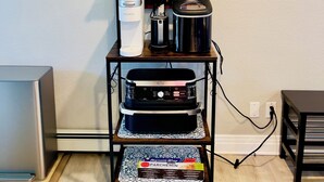 A kitchenette with a coffee maker, a rice cooker, and a coffee machine on a shelf. - Getaway Spot Close to Red Rocks, Denver, Mtns (Lakewood)