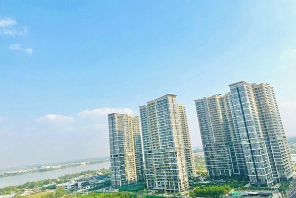 Three high-rise residential buildings with a river in the background.