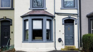 A two-story building with a bay window, a front door, and a small front yard. - 6 Bedroom Victorian Terrace, 3.5 baths (Hensingham)