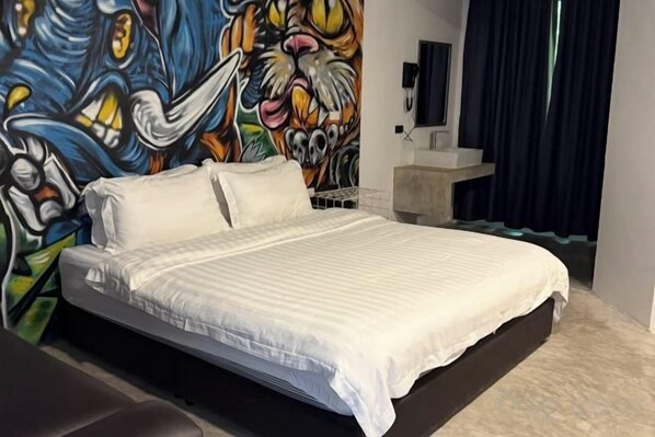 A bed with a white bedspread, a headboard, and a wall mural. - G Lighthouse (Chiang Mai)