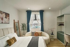 A modern bedroom with a bed, a bedside table, a chair, a wardrobe, and a window with curtains. - Venus Secret Hotel Aeon Bình Tân (Ho Chi Minh City)