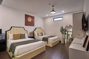 A hotel room with two beds, a desk, a mirror, a clock, and a window. - Venus Secret Hotel Aeon Bình Tân (Ho Chi Minh City)