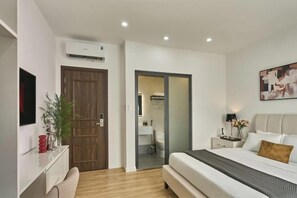 A modern bedroom with a bed, bedside table, and a wall-mounted TV. - Venus Secret Hotel Aeon Bình Tân (Ho Chi Minh City)