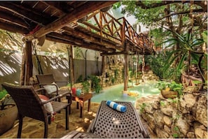 Una piscina al aire libre, sillones reclinables de piscina