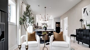 A modern living room with white sofas, a coffee table, and a decorative tree. - The Boro Suite I 3BR Near Downtown & MTSU w/ Ping Pong (Murfreesboro)