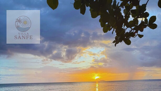 A beach with a logo of Villa Sanfe. - Beachfront Modern Apt with Direct Sand Access in Sunny Rincon - Villa Sanfe (Rincón)