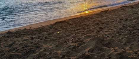 A beach with a logo of Villa Sanfe.