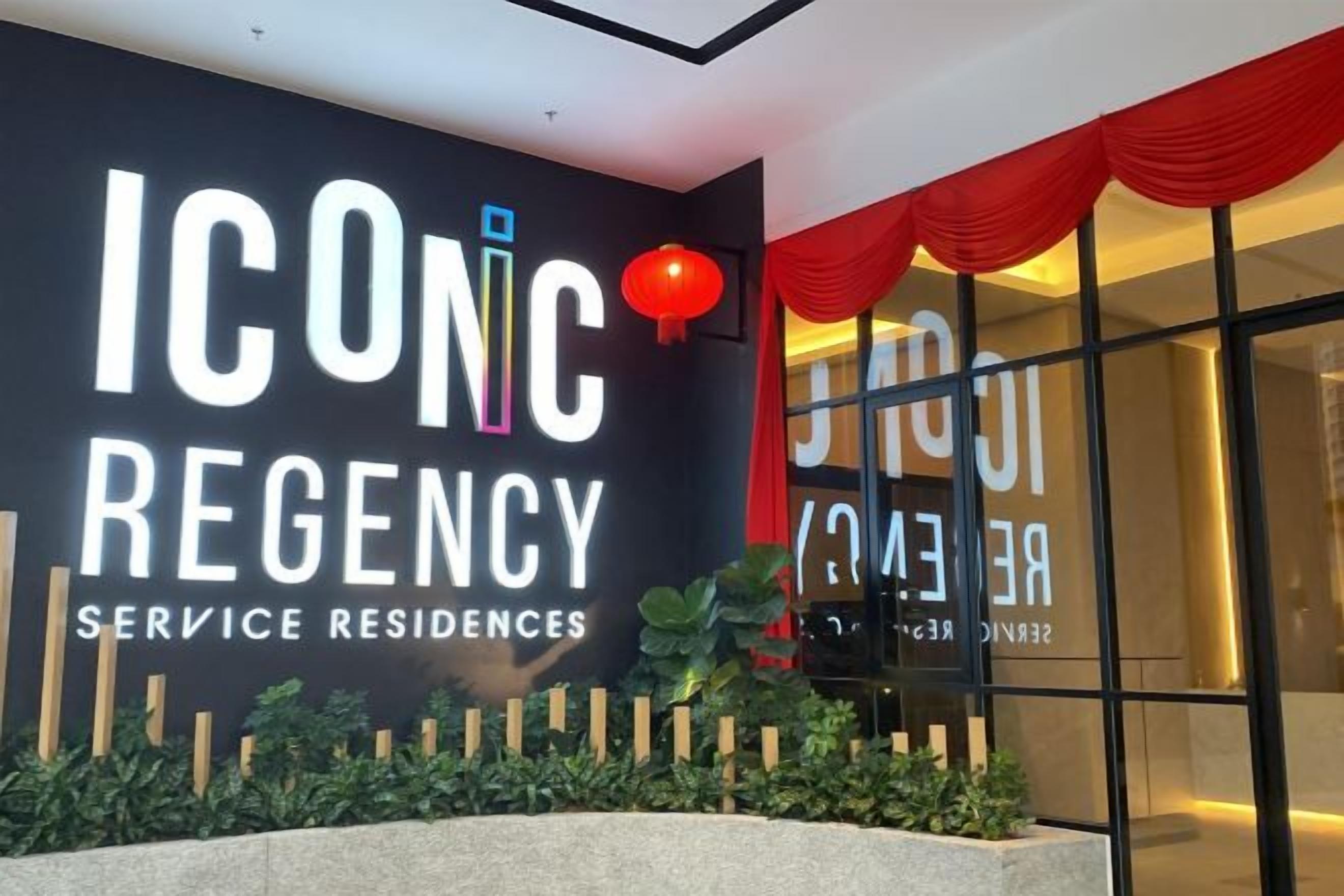 The ICONC REGENCY service residence entrance with a modern design, including a large sign and a red lantern.