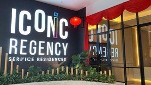 A sign for ICONC REGENCY SERVICE RESIDENCES with a red lantern and a modern building facade. - Cozy 2BR Sky Pool & Panoramic Views 1-6 Guests (Gelugor)