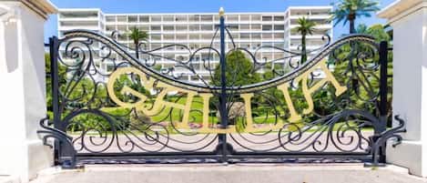 A wrought iron gate with the word 'CHILI' in gold lettering.