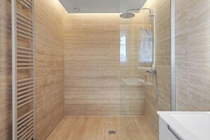 A modern shower with a glass door, a metal towel rack, and a white bathtub. - The Suite du Comte - Private Terrasse and Park View (Cannes)