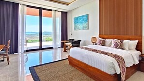 A hotel room with a large bed, a desk, a chair, and a view of the outdoors. - Villa Teraum (Pujut)