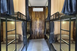 A bunk bed room with a wooden wall and an air conditioning unit. - Venn Hostel (Vientiane)
