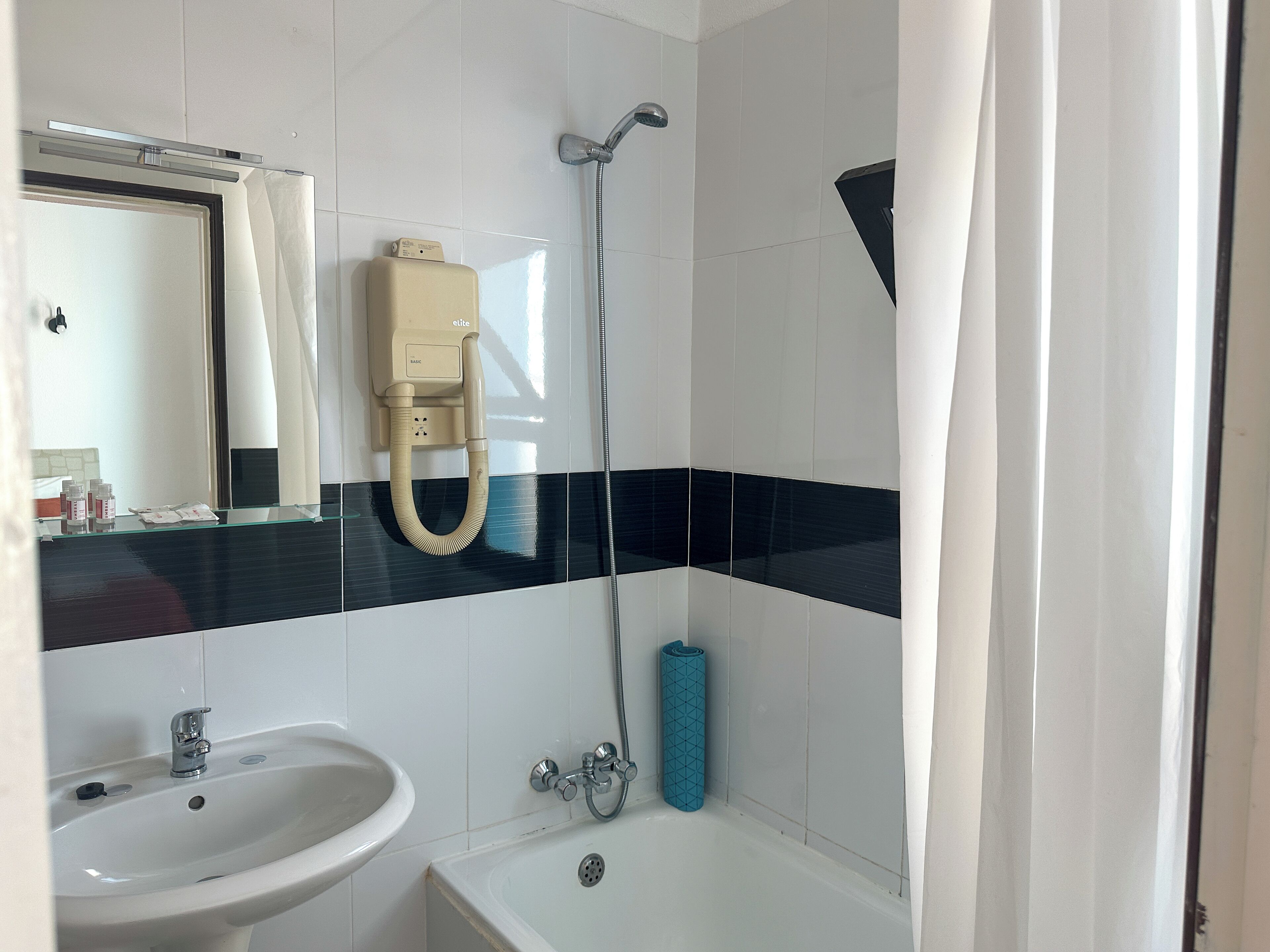 A bathroom with a sink, bathtub, and shower.