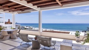 A covered outdoor seating area with a view of the ocean and beach. - Oceanfront 2BR • Elevated Views • Large Terrace (Los Cerritos)