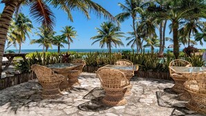 A patio with wicker furniture and a view of the ocean. - La Beliza Resort (San Pedro)