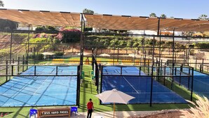 A sports facility with multiple courts, a covered seating area, and a sign reading "LOVE HARD PADEL". - Domina Coral Bay 1 or 2 rooms sea view terrace  (South Sinai Governorate)