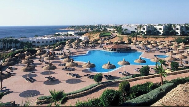 A resort with a large pool, sun loungers, and umbrellas. - Domina Coral Bay 1 or 2 rooms sea view terrace  (South Sinai Governorate)