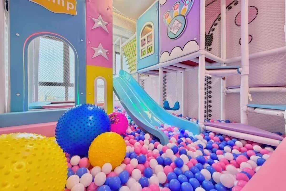 A children's play area with a ball pit, slides, and play structures.