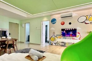 A modern hotel room with a bed, a dining area, and a TV. - Bali Residence Melaka by Heystay Management (Melaka)