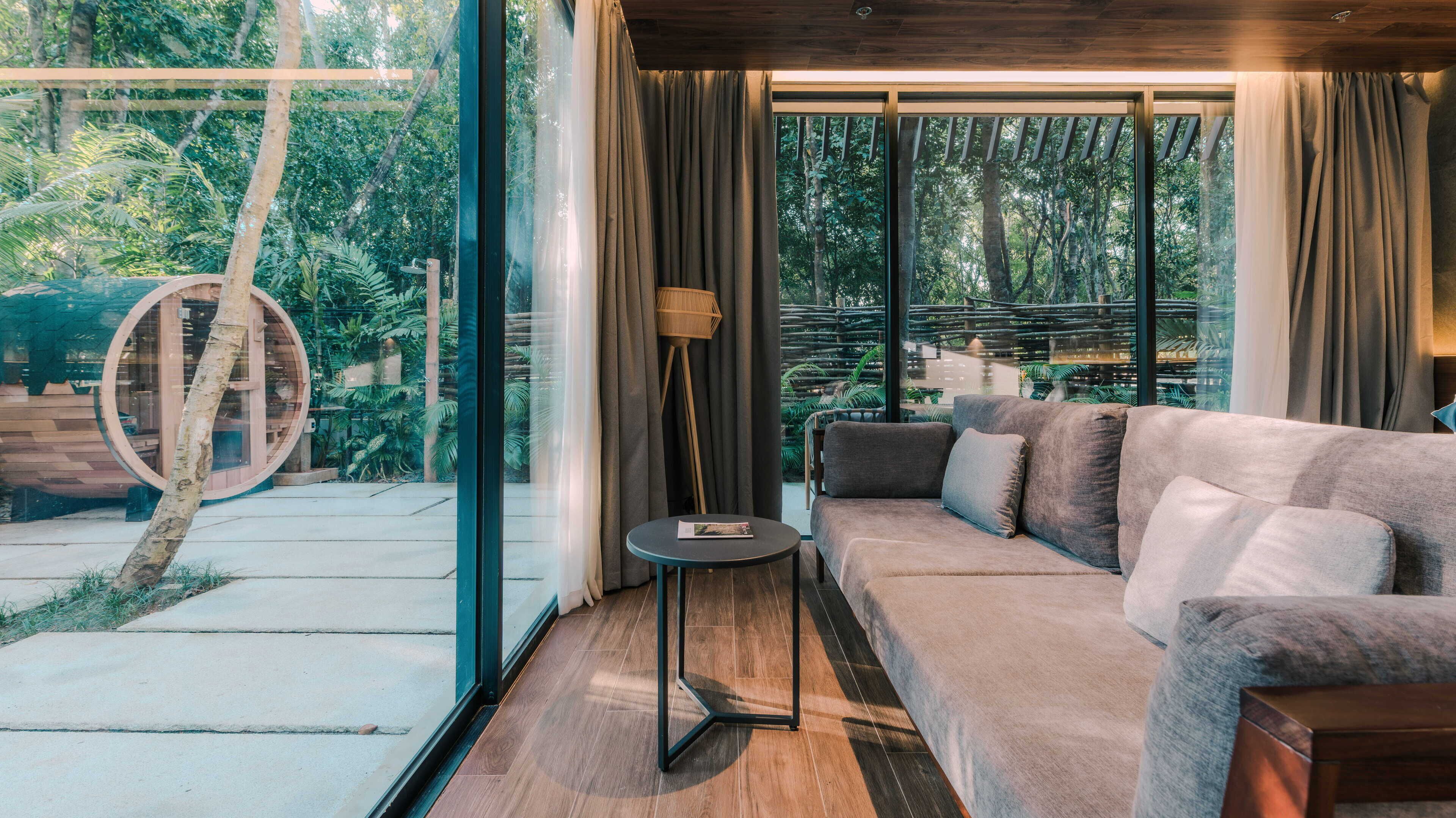 A modern living room with a sofa, a small table, and a floor lamp.