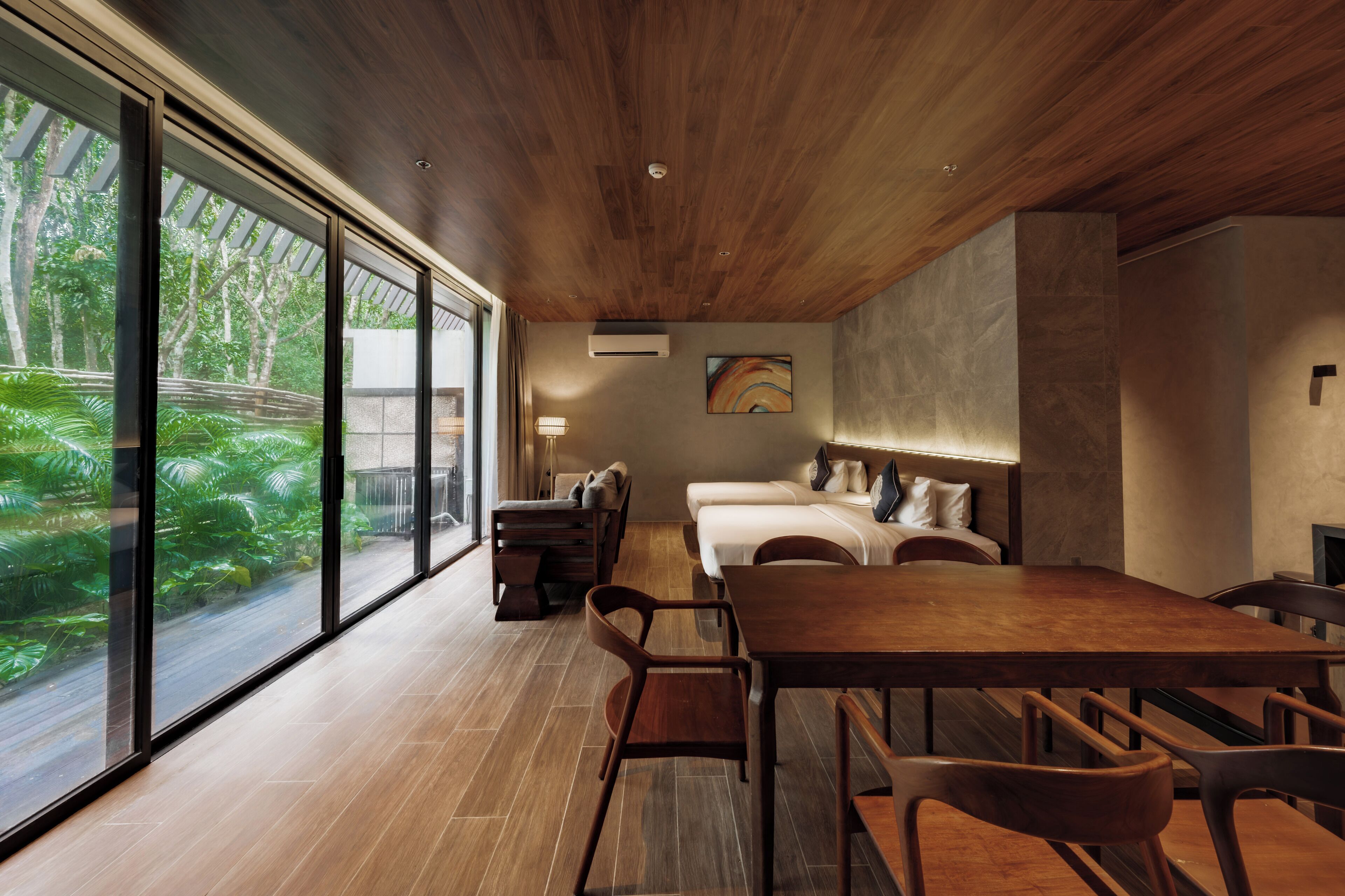 A modern room with a large window, a wooden ceiling, a bed, a desk, and a chair.