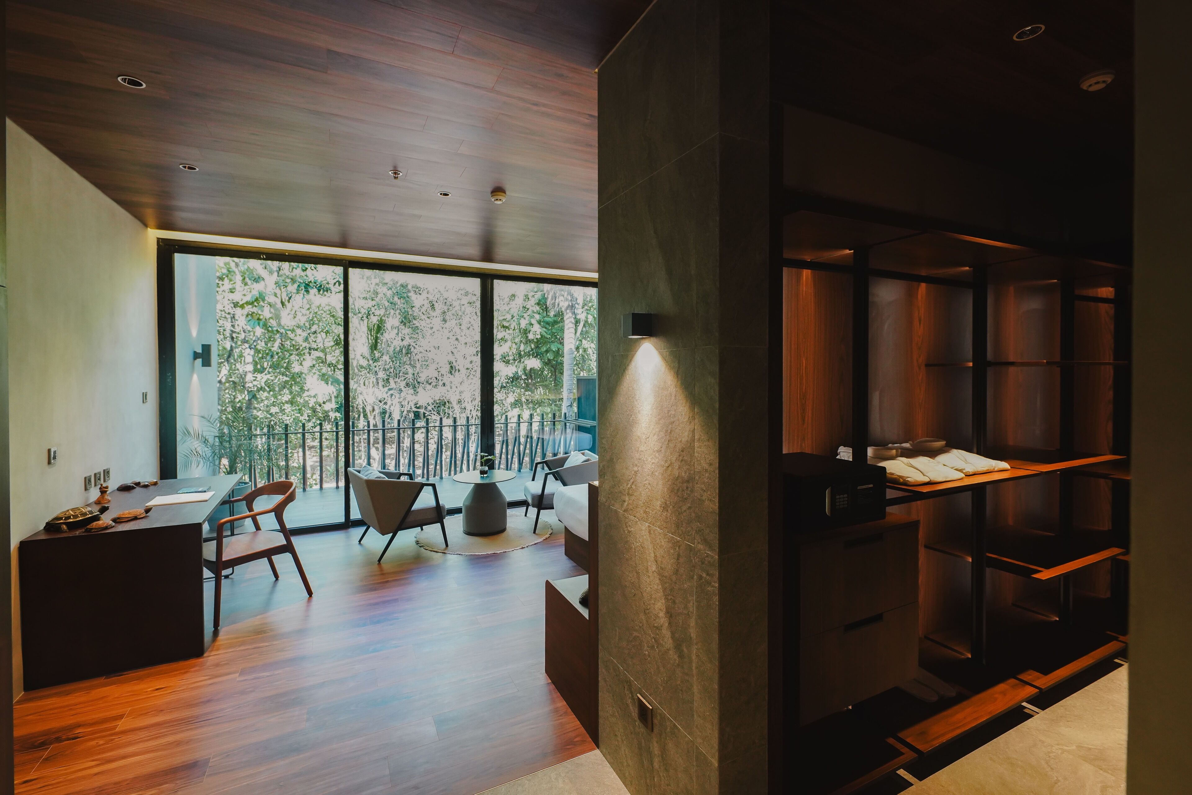 A modern interior with a dining area, a kitchen, and a built-in bookshelf.