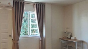 A room with a window, curtains, a desk with a chair, and an air conditioning unit. - The 5ive Homestay (Chiang Rai)