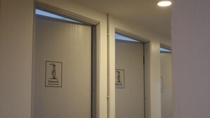 A hallway with doors marked for a sauna and a shower. - The 5ive Homestay (Chiang Rai)