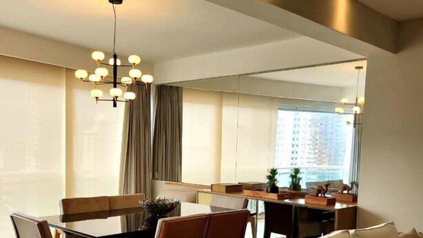 A modern living room with a sofa, chairs, a dining table, and a chandelier. - Charming Apartment (Belém)