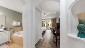 A hotel room with a bathroom, a dining area, and a view of the outside. - Seven Eagles Springs: Near Disney, Golf, Free Water Park (Kissimmee)
