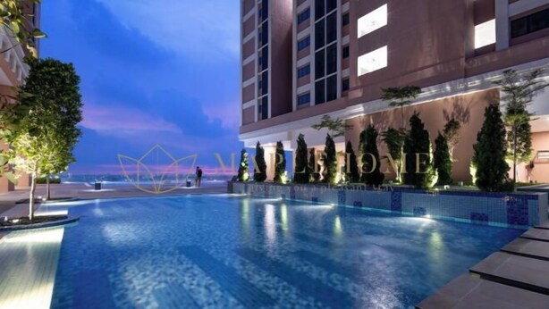 A swimming pool with a view of the sea, surrounded by buildings and trees. - EduSentral Premier Suites Setia Alam (Shah Alam)