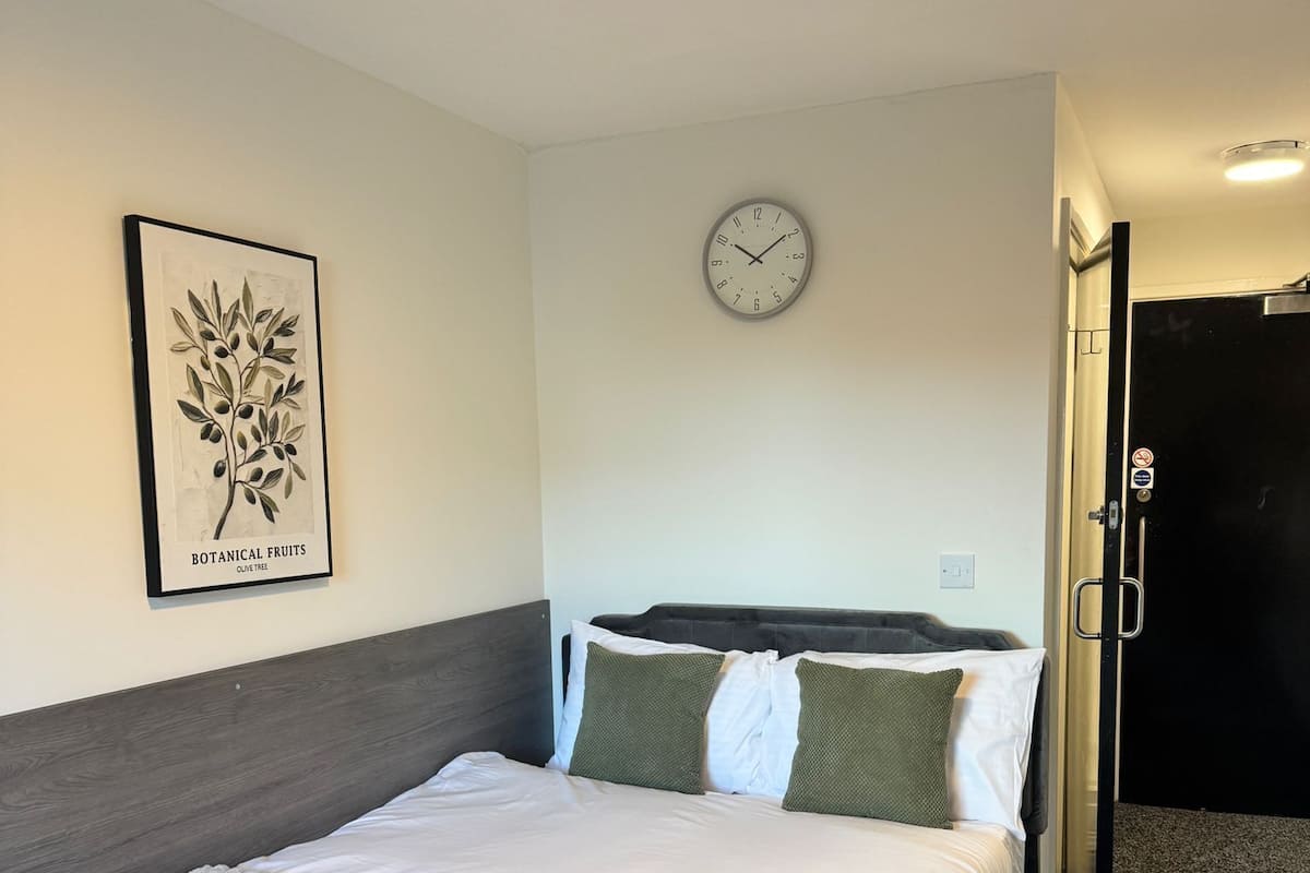 Economy Double Room | Desk, laptop workspace, blackout drapes, iron/ironing board