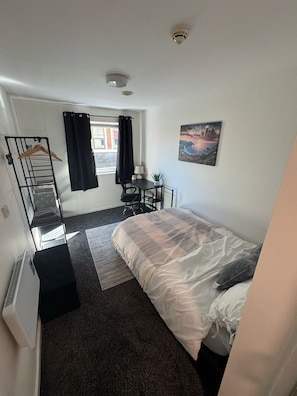 Economy Double Room | Desk, laptop workspace, blackout drapes, iron/ironing board