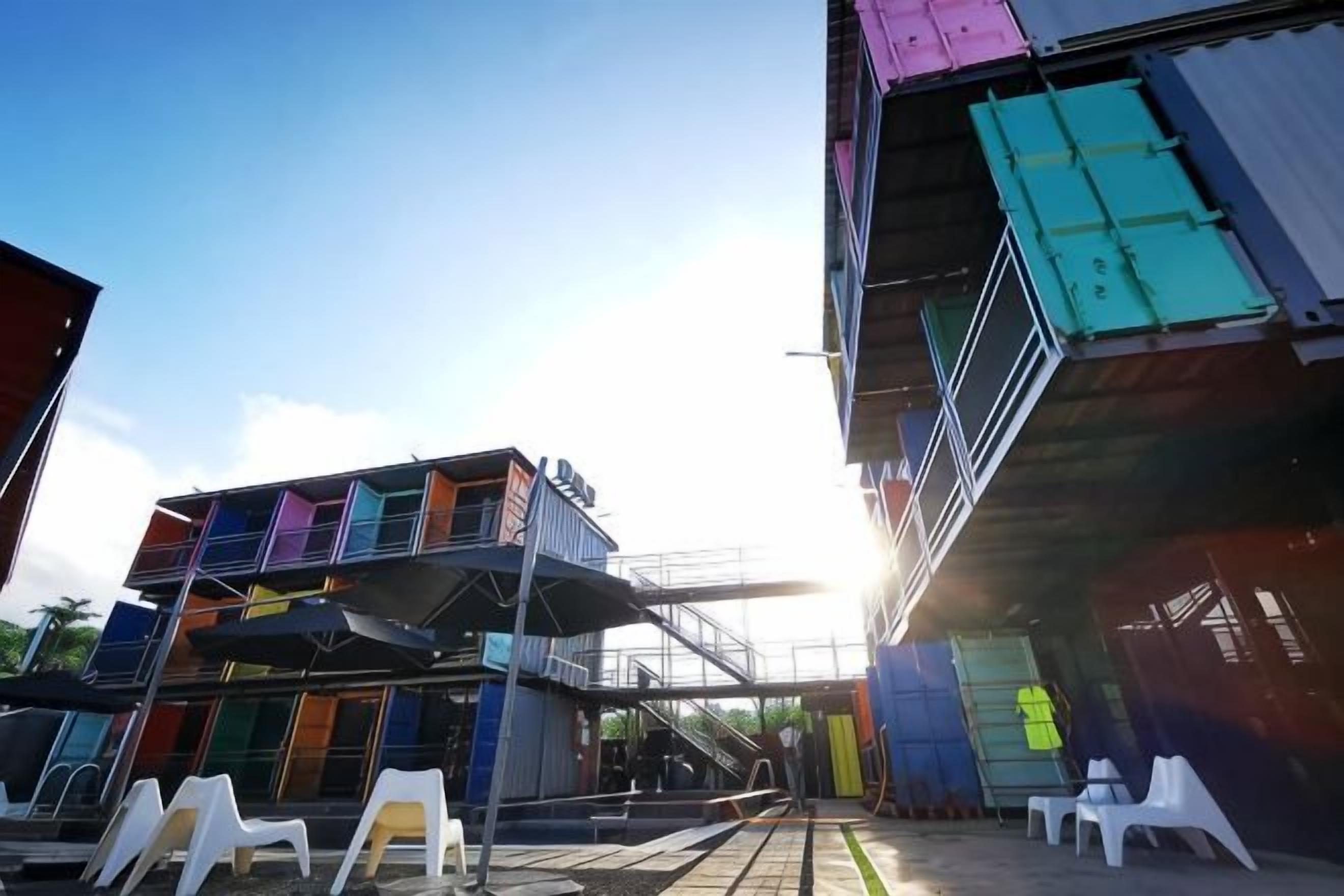 A multi-level building with outdoor seating and a staircase.