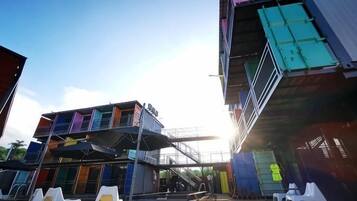 A multi-level building with outdoor seating and a staircase.