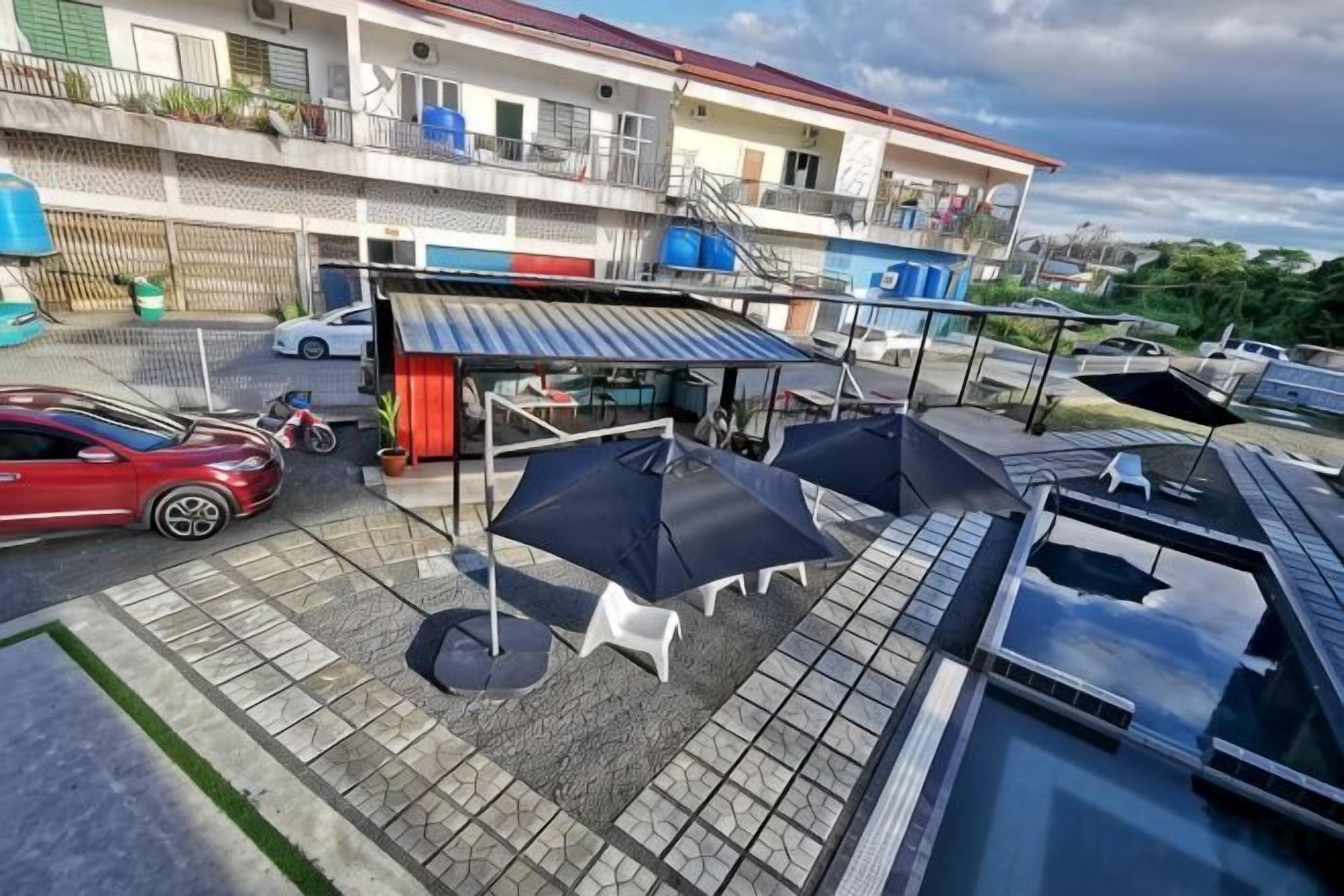 A rooftop patio with outdoor seating, a covered area, and a swimming pool.