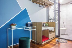 A modern bathroom with a wooden vanity, a glass shower enclosure, and a blue accent wall. - 270° Seaview, Rumahku Gurney (George Town)