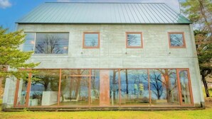 A two-story building with a metal roof and large windows. - Toyako Villa Susukian (Usu District)