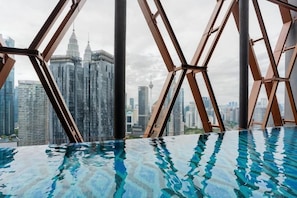 A pool with a cityscape view, surrounded by a geometric metal structure. - SCARLETZ BY FEEL HOME (Kuala Lumpur)