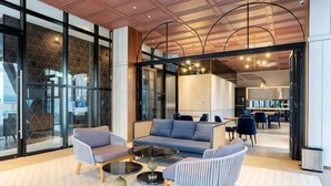 A modern lounge area with sofas, chairs, and a coffee table.