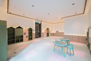 A children's play area with a table and chairs, a bookshelf, and a door. - SCARLETZ BY FEEL HOME (Kuala Lumpur)