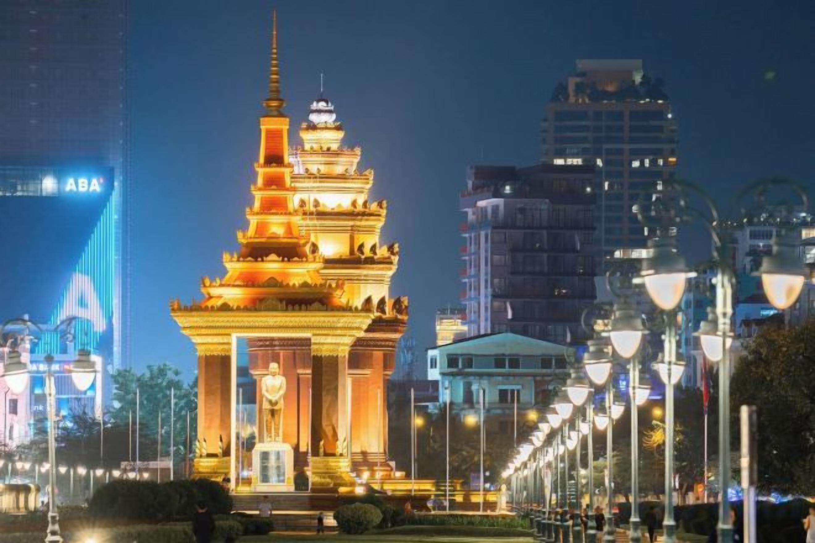 A multi-tiered pagoda-style structure with a central entrance, surrounded by a well-lit street with modern buildings in the background.
