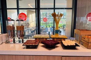 A buffet with various food items displayed on trays and in containers. - The Cam Ranh Oceanview (Cam Ranh)