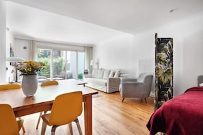 A modern room with a dining table, chairs, a sofa, and a bed. - NOA - Tatar Beyi 18 (Istanbul)